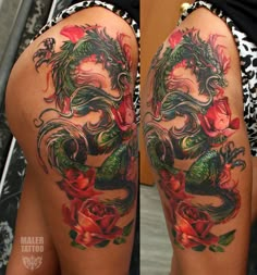 a woman's thigh with a dragon tattoo on her leg and roses in the background