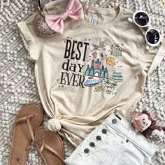 a t - shirt that says best day ever next to some sandals and other items