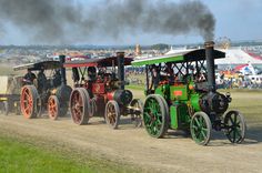 an old timey steam engine train traveling down a dirt road