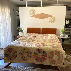 a bed with a quilt on it in a room