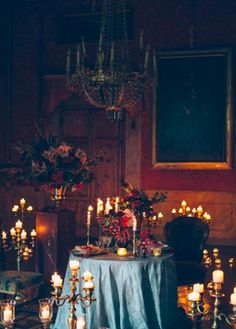 a table with candles and flowers on it