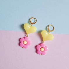 Flower power heart pink and yellow pendant earrings 💕🌼 Handmade with acrylic beads and stainless steel hoops.  Dimensions: 🌼Flower bead 2cm 💛Heart bead 1.5x2cm 🌼Length 5.5cm Pink Heart-shaped Flower Earrings As Gift, Pink Heart-shaped Flower Earrings For Gift, Playful Pink Flower Earrings, Pink Dangle Heart Earring, Fun Pink Flower Earrings As Gift, Playful Yellow Drop Earrings Jewelry, Pink Fun Flower Earrings For Gift, Fun Pink Flower Earrings For Gift, Playful Pink Heart Earrings As Gift