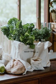 a bag filled with vegetables sitting on top of a wooden table