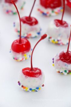 small desserts with cherries and sprinkles on them are ready to be eaten