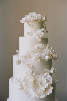 a white wedding cake with flowers on top