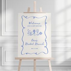 an easel with a wedding welcome sign on it in front of a white wall