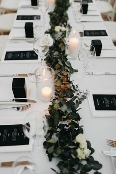 the table is set with candles and place settings