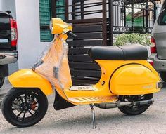 a yellow scooter parked in front of a building