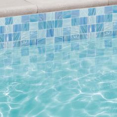 an empty swimming pool with clear blue water