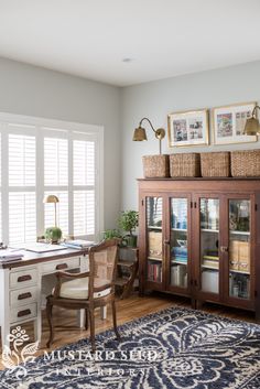 a living room filled with furniture and a large rug on top of a hard wood floor