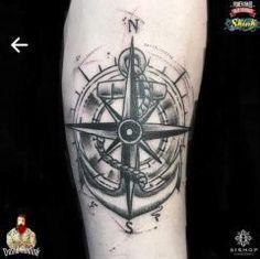 a black and white compass tattoo on the leg