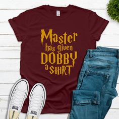 "Master has Given Dobby a Shirt! Whether you are a Dobby fan, HP fan, or simply can relate to being given a shirt, this soft unisex tee is for you. Our Master has Given Dobby a Shirt design works great for a Universal Vacation or for a HP birthday or fan gift. Designs are printed on to our shirts with a process called \"Direct Printing.\" The ink is infused into the fabric which creates a longer-lasting and higher-quality image when compared to vinyl or heat transfer.  The adult shirts we use ar Harry Potter Shirt Design, Legoland Shirts, Universal Tshirts, Universal Trip, Universal Vacation, Universal Shirts, Casual Street Wear, Harry Potter Shirts, Tshirt Funny