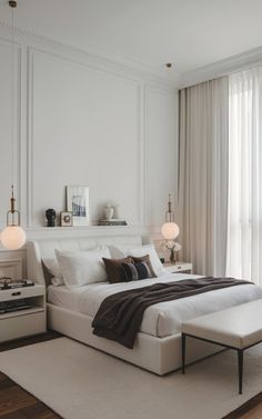 a white bed sitting next to a window in a bedroom on top of a hard wood floor