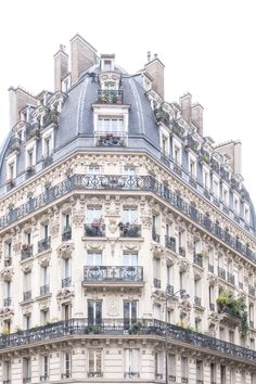 a tall building with many windows and balconies