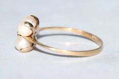 Stunning vintage 18K yellow gold ring showcasing a 4 3 mm cultured pearls and a .04 CT prong set diamond in it's center. This ring is a size 6 and can be sized if needed. This ring has a total weight of 1.3 grams , is hallmarked 750 18K yellow gold and has been checked by a professional for authenticity. Heirloom Pearl Ring Stamped 14k For Wedding, Heirloom 14k Stamped Pearl Ring For Wedding, Antique 14k Gold Pearl Wedding Ring, Vintage Yellow Gold Pearl Ring, Victorian 14k Yellow Gold Pearl Ring, Victorian Style 14k Yellow Gold Pearl Ring, Antique 14k Stamped Pearl Ring For Wedding, Antique 14k Stamped Pearl Wedding Ring, Antique 14k Gold Pearl Ring For Anniversary