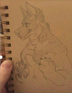 a drawing of a dog is being held by someone