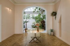 an entry way with a table and potted plants