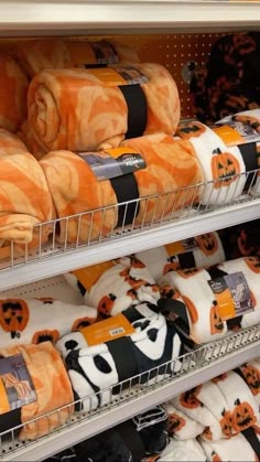 towels and pumpkins are on display in a grocery store's shelve