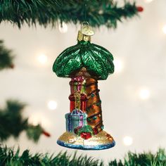 a bell ornament hanging from a christmas tree