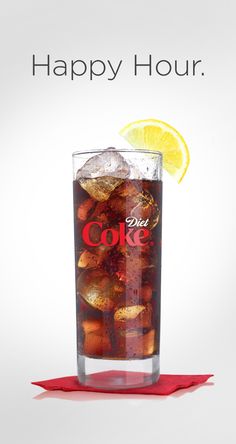 a glass filled with coke sitting on top of a table