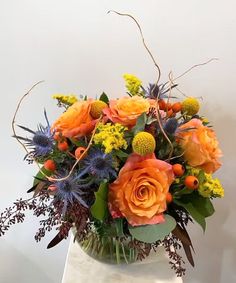 a vase filled with orange and purple flowers