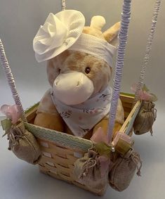 a stuffed animal in a basket with two strings attached to it's head and nose