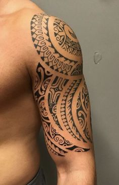 a man's arm with an intricate tattoo design on his left arm and chest