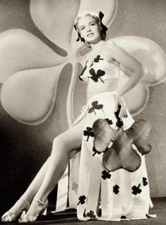 a woman in a costume posing for the camera with her legs spread out and one leg up