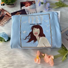 a blue bag with an image of a woman's face on it and flowers in the background