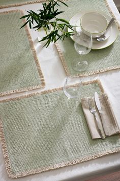 a place setting on a table with plates and silverware