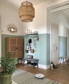 a living room filled with furniture and a potted plant on top of a wooden table