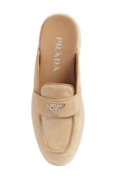 Prada's iconic triangular logo shines at the keeper strap of this easygoing loafer mule crafted of velvety suede and grounded by a rubber sole. Leather upper and lining/synthetic sole Made in Italy Women's Designer Shoes Designer Suede Loafers With Flat Heel, Luxury Mules With Rubber Sole, Luxury Suede Loafers With Flat Heel, Luxury Beige Suede Loafers, Luxury Suede Mules For Formal Occasions, Luxury Suede Mules With Suede Lining, Luxury Suede Mules With Round Toe, Loafer Mules, Footwear Design Women