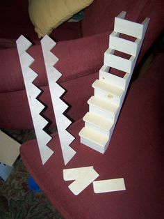 two pieces of wood sitting on top of a red couch