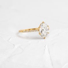 an oval diamond engagement ring set in yellow gold