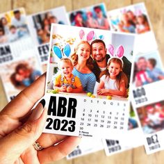 a person holding up a calendar with an image of two people and one child on it