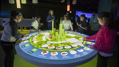 people standing around a table with a game on it