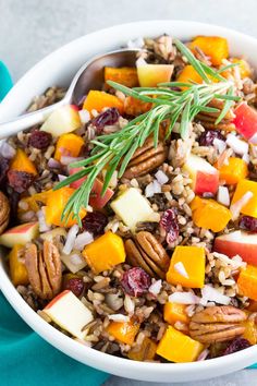 a white bowl filled with fruit and nuts