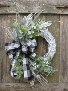 a wreath is hanging on the side of a wooden door