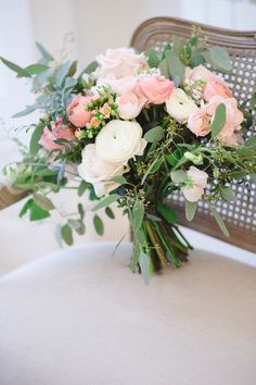 a bouquet of flowers sitting on top of a chair