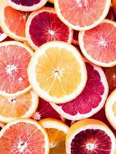 a pile of cut up grapefruits and oranges