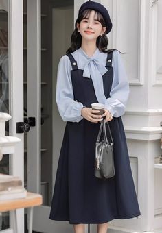 Preppy twofer midi dress with a faux layered look. Features tie neck blouse with long sleeves, a cami pinafore bodice with side pockets and embellished with golden buttons. Concealed side zipper closure. S: 33" chest, 26" waist, 44" lengthM: 34.5" chest, 27.5" waist, 44" lengthL: 36" chest, 29" waist, 44.5" lengthXL: 37.5" chest, 30.5" waist, 44.5" length Cute Shoes Boots, Muslim Outfits, Tie Neck Blouse, Navy Midi Dress, Overall Dress, Layered Look, Sweater Blouse, Cardigan Jacket, Neck Tie