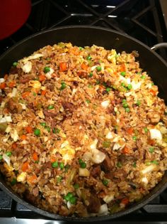 a pan filled with food sitting on top of a stove