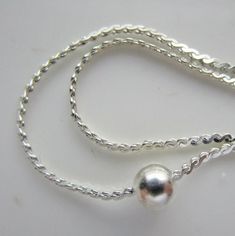 A pretty delicate silver-plated steel snake chain necklace that measures 15.5 inches long. The flat chain is just 1mm wide and has three evenly-spaced 4mm round silver balls in the center. The spring ring closure has a flat teardrop-shaped tab. Very good condition. We have 2 available. Find more jewelry here: https://www.etsy.com/shop/ASmallCraftsAdvisory?ref=seller-platform-mcnav&section_id=30395744 Return to our main shop page here: http://www.etsy.com/shop/ASmallCraftsAdvisory/ Like our shop on Facebook to hear about new listings and special sales: http://www.facebook.com/asmallcraftsadvisory/ Silver Snake Chain Necklace With Adjustable Chain, Dainty Silver Snake Chain Necklace With Adjustable Chain, Dainty Silver Snake Chain Necklace With Delicate Chain, Dainty Silver Snake Chain Necklace With Delicate Details, Silver Adjustable Snake Chain Necklace, Adjustable Silver Snake Chain Necklace, Silver Snake Chain Necklace With Adjustable Chain For Gift, Dainty Silver Snake Chain Necklace, Small Clock