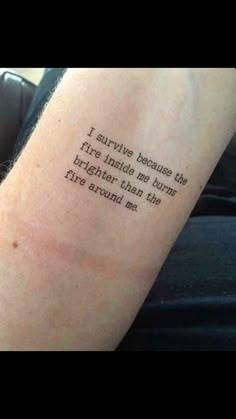 a person with a tattoo saying i survived because the fire inside me burns brighter than the fire around me