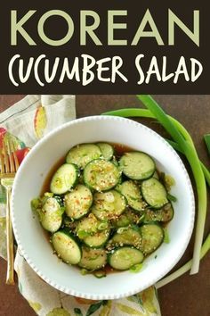 a white bowl filled with cucumber salad on top of a table