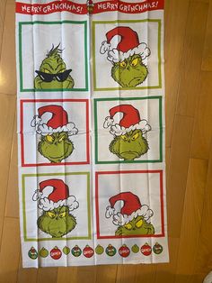 the grinch christmas tea towel is hanging on the wall in front of a wooden floor