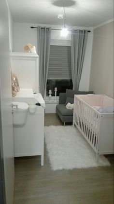 a baby's room with a crib, couch, and bed in it