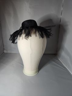 This flapper-inspired hat fastener is simply and fun.  Perfect for Halloween or any Gothic occasion,  this hat can be worn in a variety of ways to add spice to most any outfit. Halloween Costume Hats And Headpieces With Short Brim, Fedora Costume Hats For Halloween Costume Party, Fedora Costume Hat For Halloween Party, Adjustable Costume Hats And Headpieces, Black Witchy Wide Brim Costume Accessories, Fedora Hat For Halloween Costume Party, Curved Brim Mini Hats For Halloween Costume Party, Halloween Fedora For Costume Party, Adjustable Hats For Halloween Costume Party