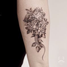 a woman's arm with flowers and fish tattoo on the left side of her body