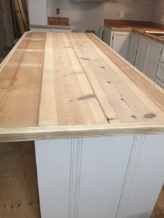 a wooden counter top in a kitchen under construction